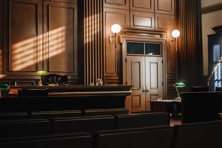 Empty American Style Courtroom. Supreme Court of Law and Justice Trial Stand. Courthouse Before Civil Case Hearing Starts. Grand Wooden Interior with Judge's Bench, Defendant's and Plaintiff's Tables.