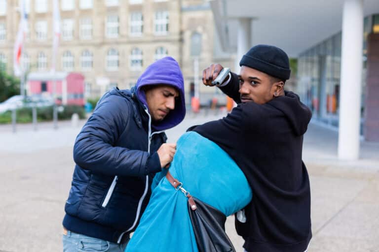 Criminal street gang of robbers taking hostage with gun